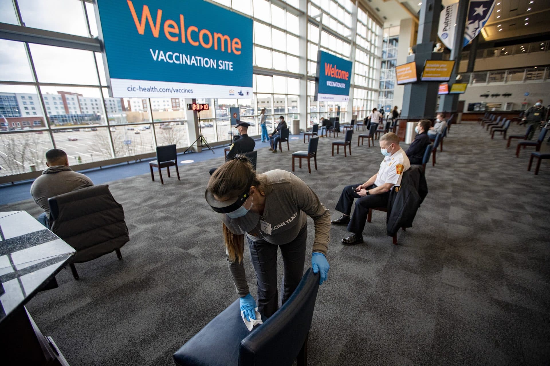 First responders sit in the waiting area for 15 minutes before leaving to ensure they do not have any adverse reactions to the Moderna COVID-19 vaccine. (Jesse Costa/WBUR)