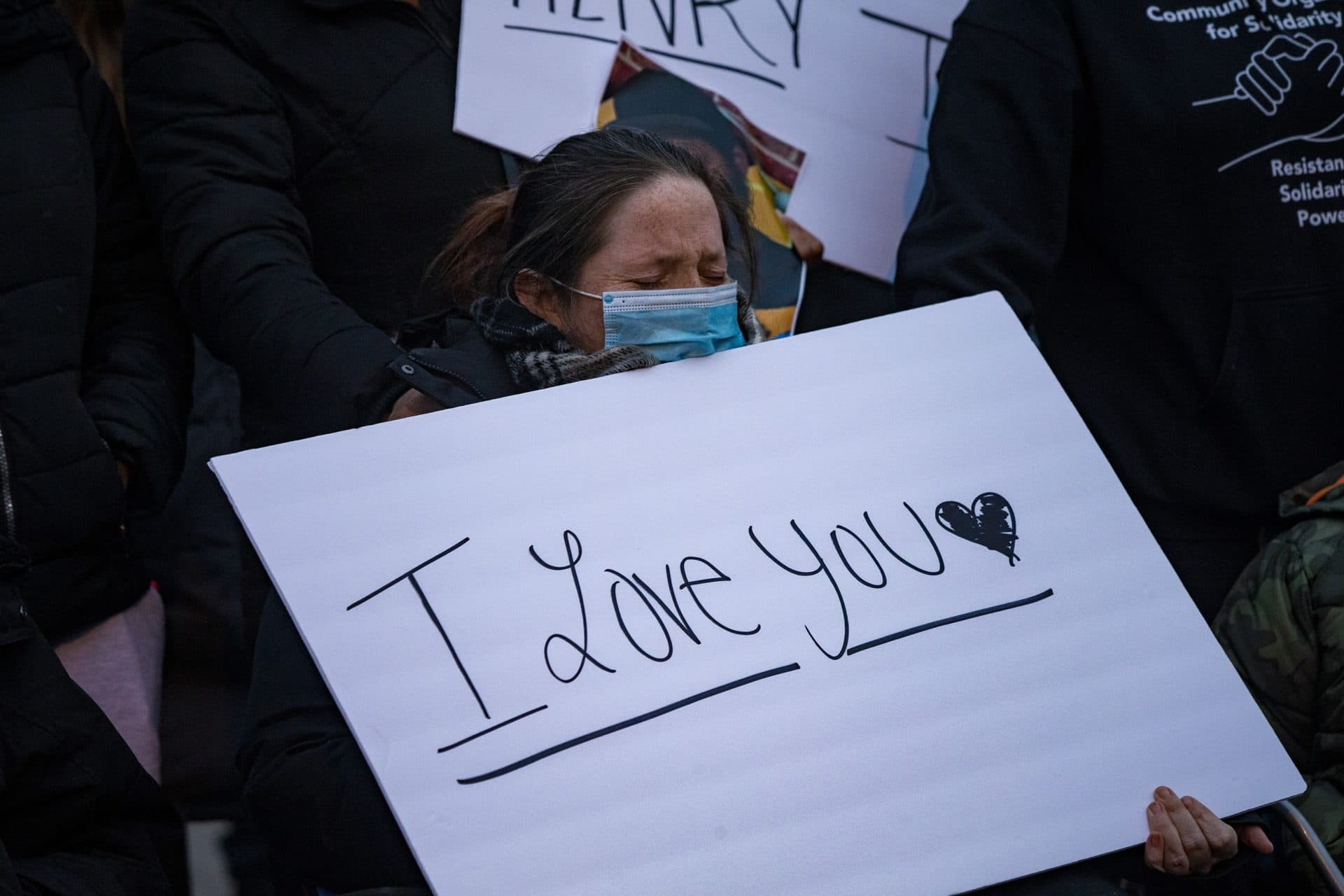 Courtney Morton grieves for the loss of her partner Henry Tapia as “Amazing Grace” is sung during the vigil. (Jesse Costa/WBUR)