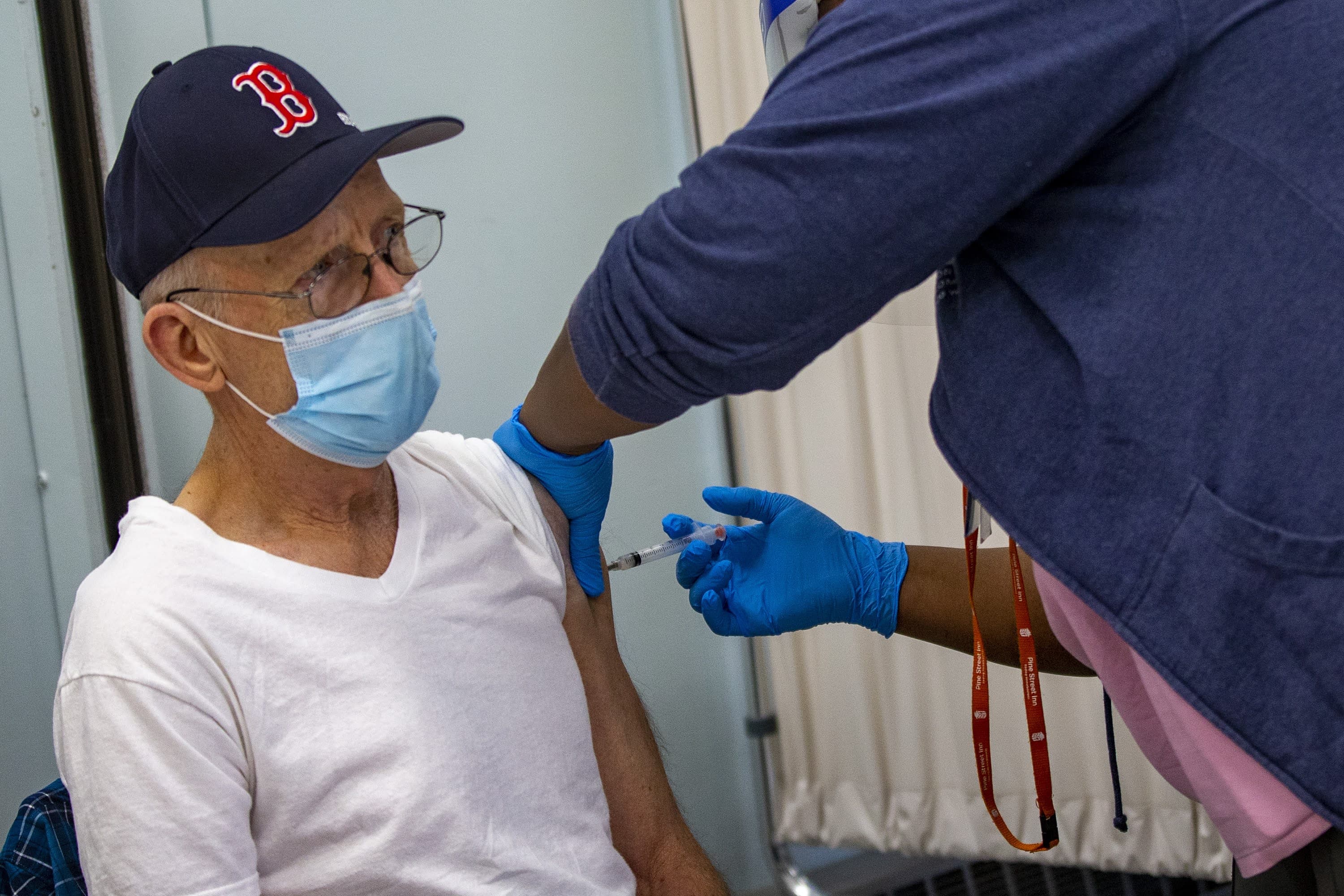 Michael Goodman, a guest at Pine Street Inn, receives the COVID-19 vaccine. (Jesse Costa/WBUR)