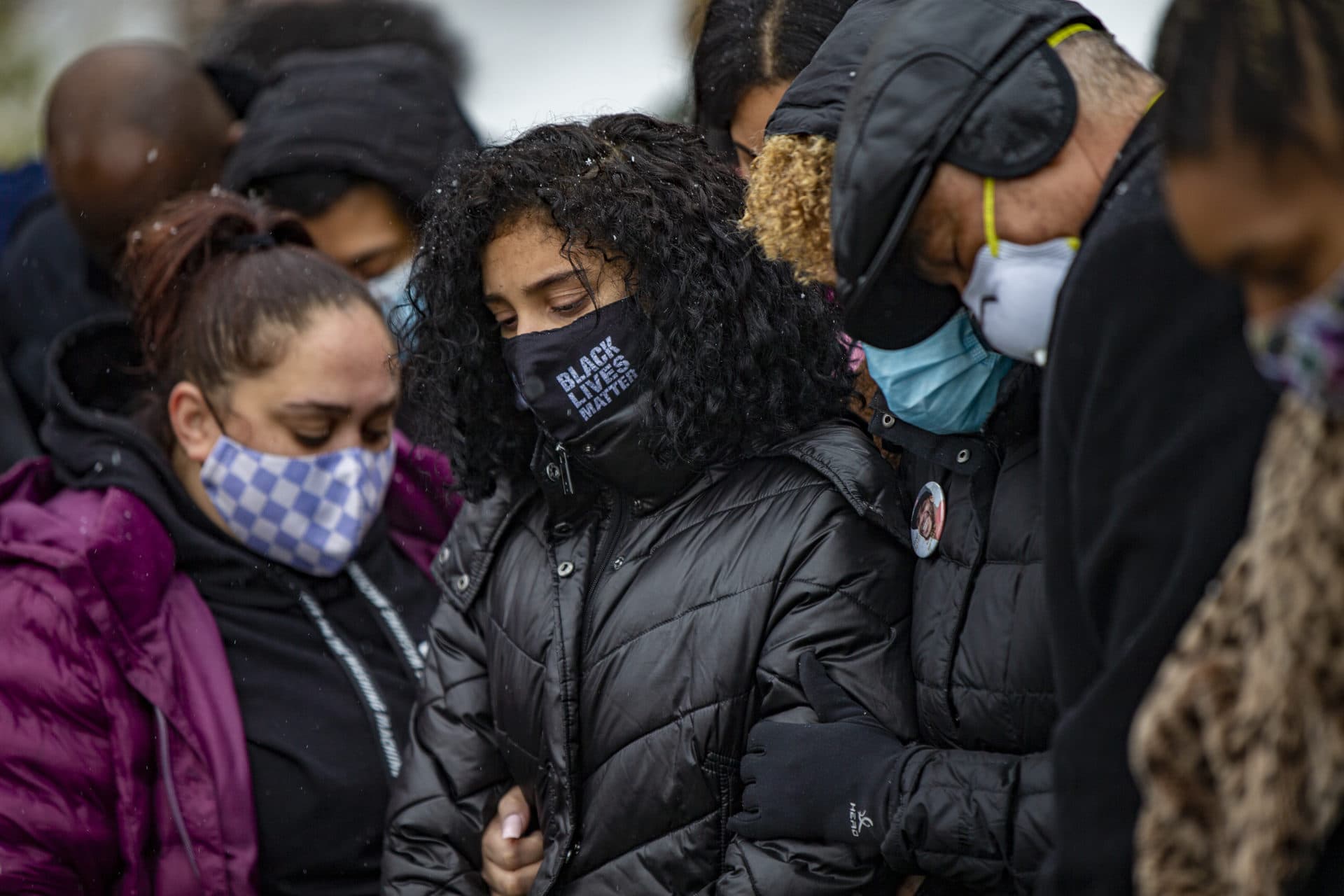 Henry Tapia’s 15-year-old daughter, Sophia, stands among family and friends during her father's burial. (Jesse Costa/WBUR)