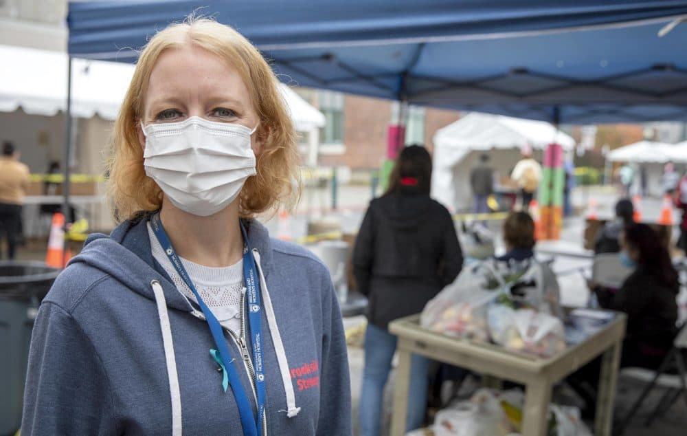 Christin Price at the Brookside Community Health Center by the food and resources tent. (Robin Lubbock/WBUR)