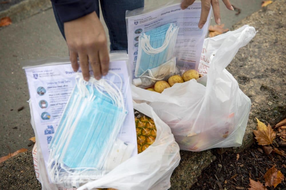 Bags of fruit, vegetables and masks available at the food and resources tent at the Brookside Community Health Center. (Robin Lubbock/WBUR)