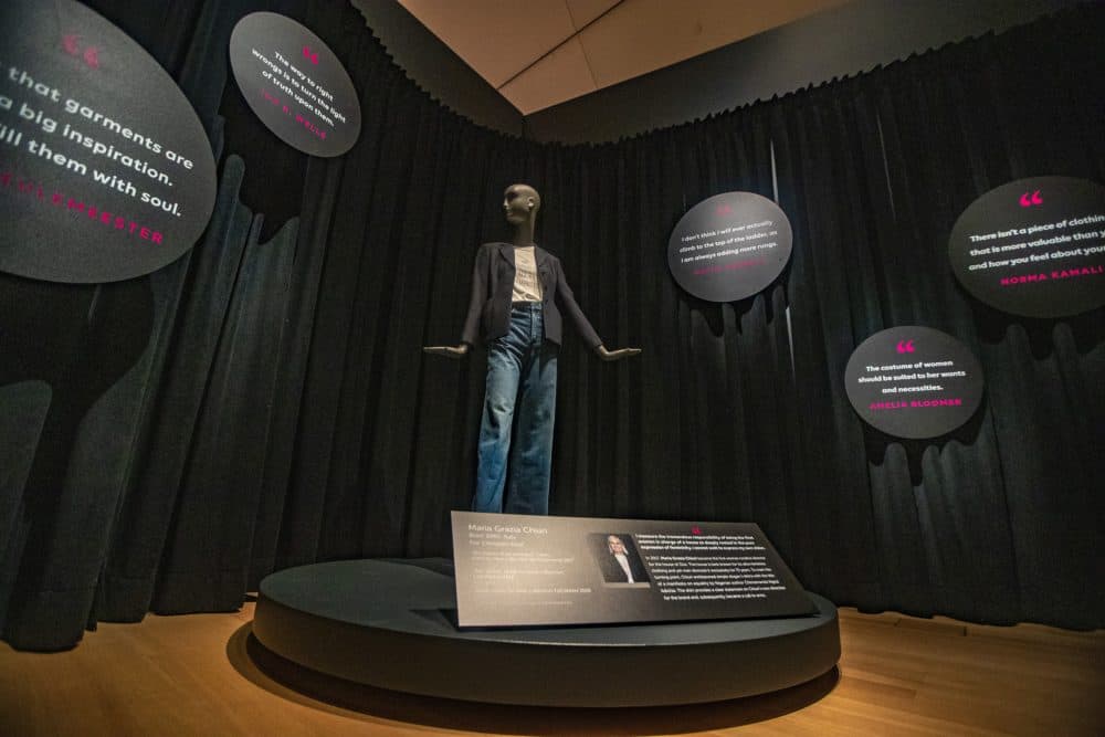 The exhibit at the Peabody Essex Museum features an outfit designed by Maria Grazia Chiuri with a t-shirt, jacket and jeans from 2019. (Jesse Costa/WBUR)