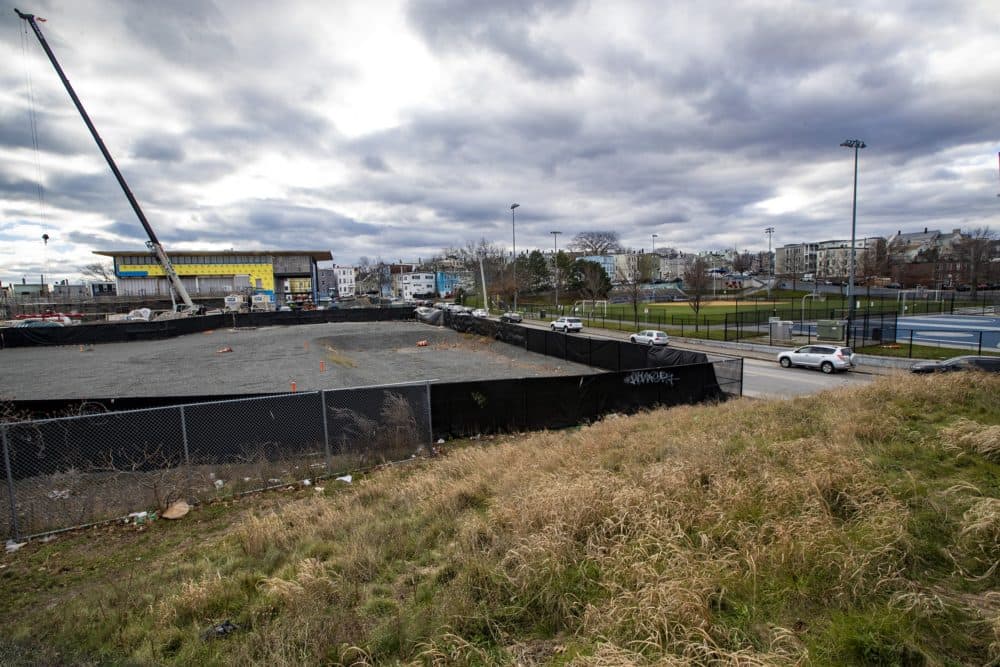 The empty lot where Eversource plans to build an electrical substation in East Boston. The site is near the banks of Chelsea Creek and the new police station, and across the street from a popular playground and park.(Jesse Costa/WBUR)