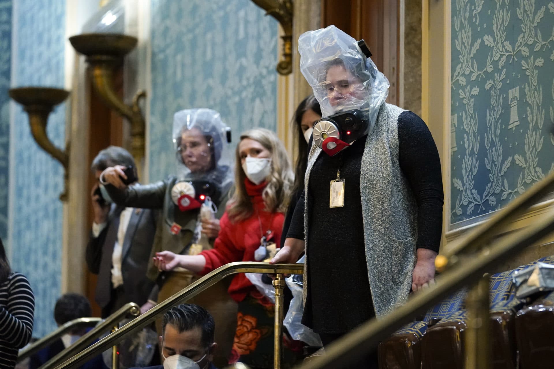 People are seen in the House gallery as protesters try to break into the House Chamber. (Andrew Harnik/AP)