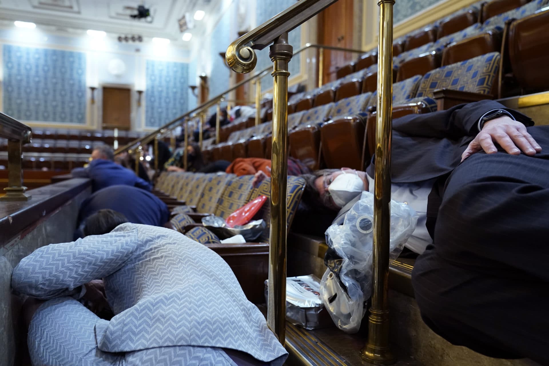 People shelter in the House gallery as protesters try to break into the House Chamber. (Andrew Harnik/AP)