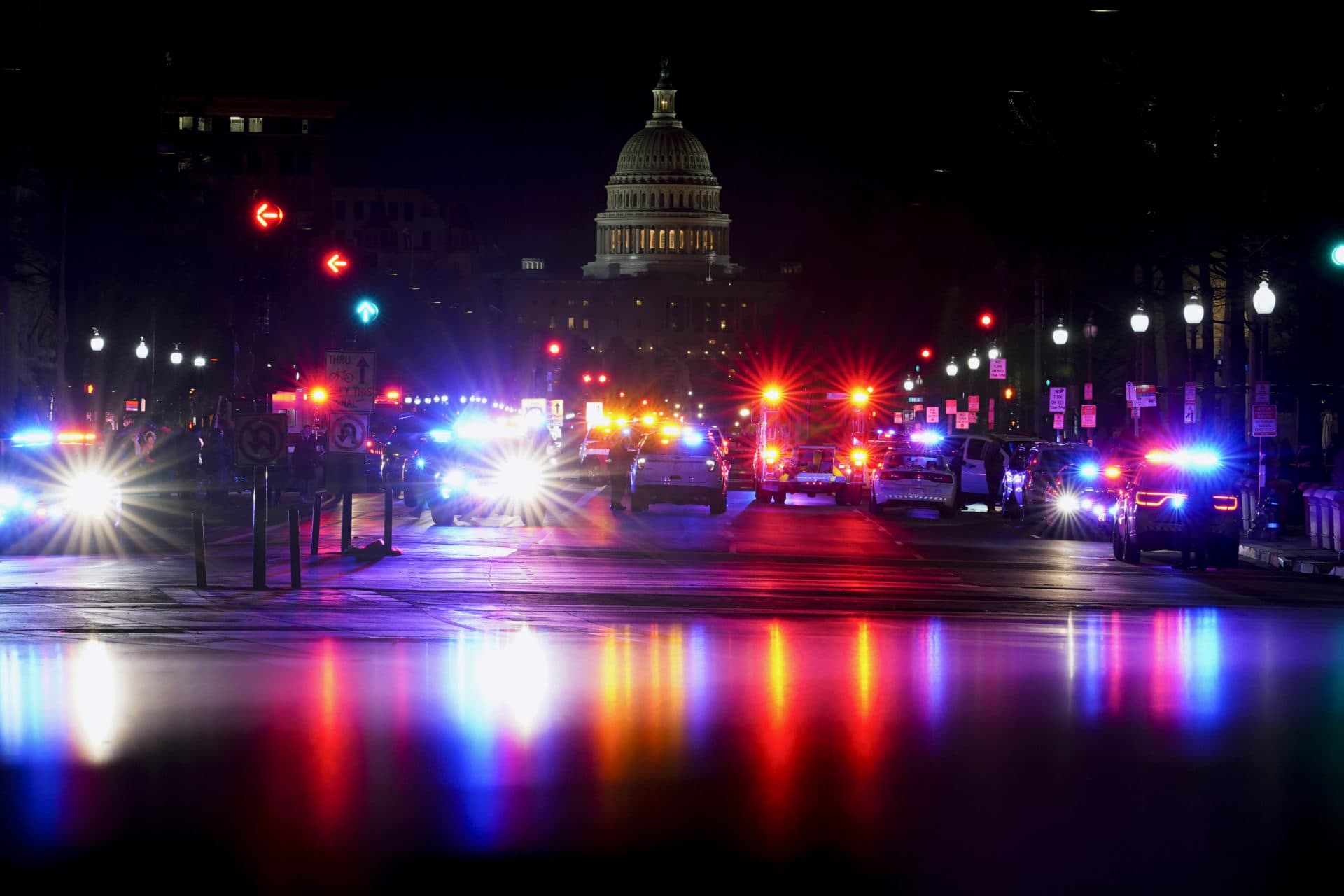 With the U.S. Capitol in the background, lights from police vehicles illuminate Pennsylvania Avenue. (Carolyn Kaster/AP)