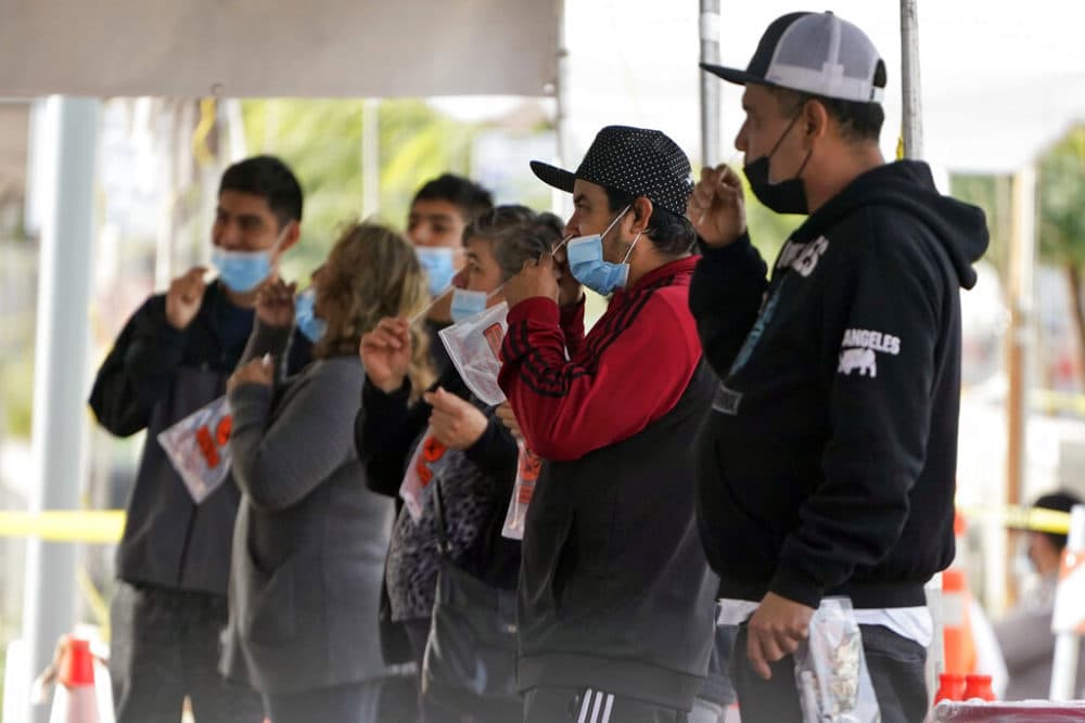 People take a COVID-19 test on the Martin Luther King Jr. Medical Campus in Los Angeles. (AP Photo/Marcio Jose Sanchez)