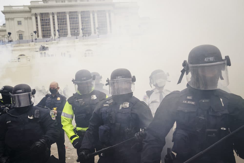 Supporters loyal to President Donald Trump clash with authorities before successfully breaching the Capitol building during a riot on the grounds, Wednesday, Jan. 6, 2021. (John Minchillo/AP)