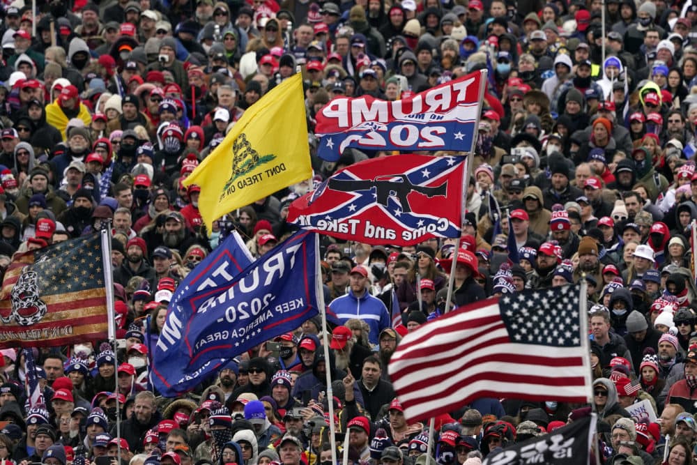 Supporters listen as former President Trump speaks as a Confederate-themed and other flags flutter in the wind during a rally in Washington on Jan. 6. (Evan Vucci/AP)