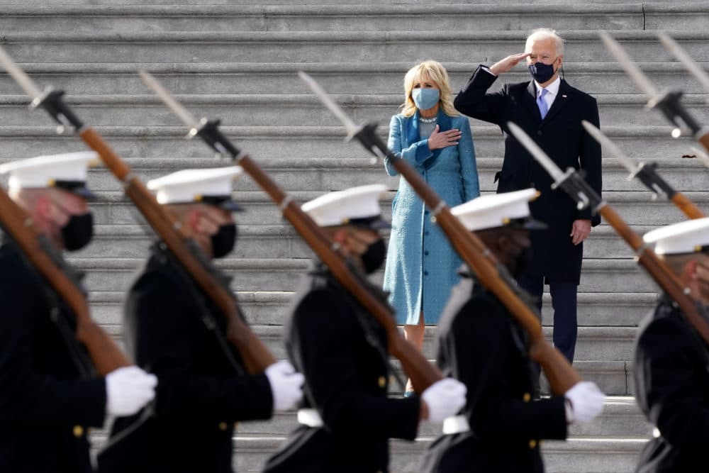 President Joe Biden and his wife Jill Biden watch a military pass in review ceremony on the East Front of the Capitol at the conclusion of the inauguration ceremonies. (J. Scott Applewhite/AP)