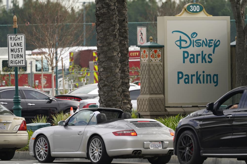 Vehicles queue up outside the Disneyland Resort parking lot for a COVID-19 vaccine in Anaheim, Calif. on Jan. 13, 2021. Disneyland — hit hard by the global health crisis — is hosting a mass vaccination effort. (Damian Dovarganes/AP File)