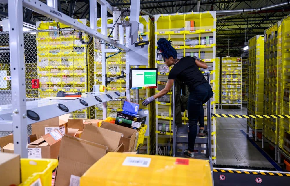 A woman works at a distribution station an Amazon fulfillment center. (Johannes Eisele/AFP via Getty Images)