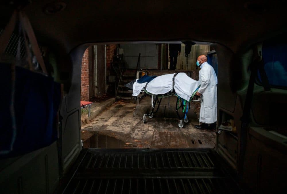 Maryland Cremation Services transporter Reggie Elliott brings the remains of a Covid-19 victim to his van from the hospital's morgue in Baltimore, Maryland on December 24, 2020 during the Covid-19 pandemic. (Andrew Caballero-Reynolds AFP via Getty Images)