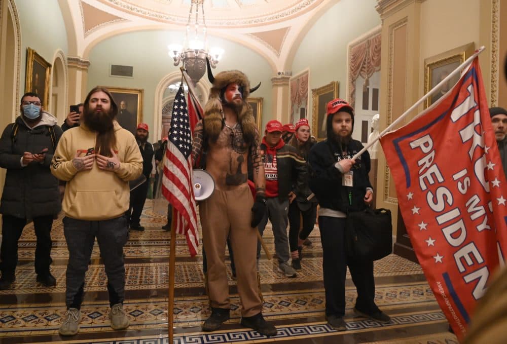 In this image taken amid the D.C. insurrection on Jan. 6, Brian McCreary, far left with the blue face mask, is reportedly seen standing inside the U.S. Capitol building with other supporters of now former President Donald Trump. (Saul Loeb/AFP via Getty Images)