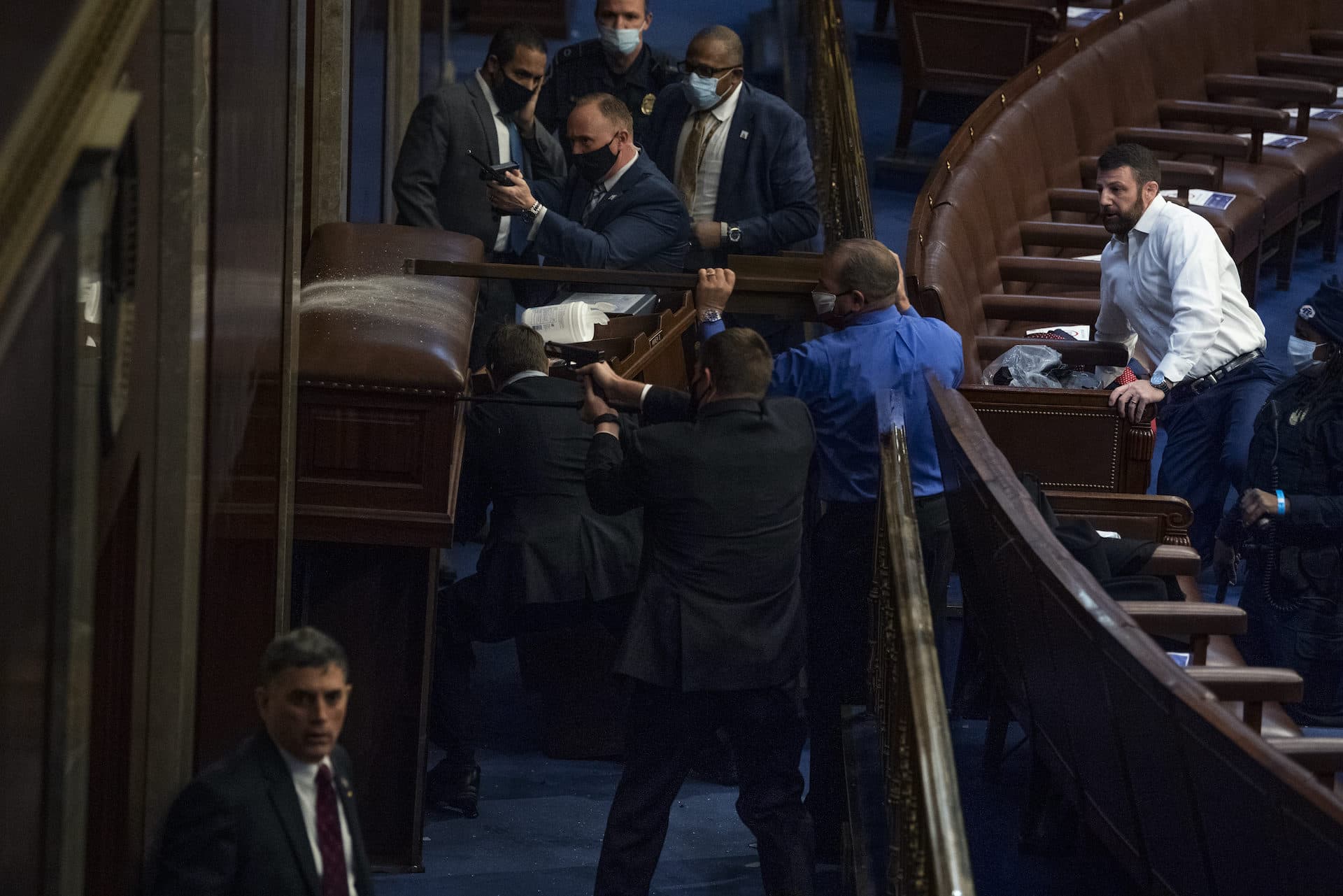 Security barricades the door of the House chamber as protesters try to break in to the joint session of Congress certifying the Electoral College vote on Wednesday. (Tom Williams/CQ-Roll Call, Inc via Getty Images)