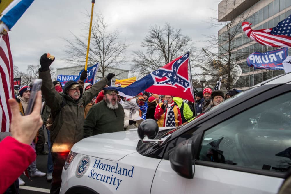 Trump supporters push back a police car while gathering outside the Capitol Building. (Probal Rashid/LightRocket via Getty Images)