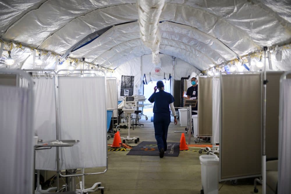 A nurse wears PPE as she attends to patients in a suspected COVID-19 patient triage area set up in a field hospital tent outside of Martin Luther King Jr. Community Hospital on Jan. 6, 2021 in Los Angeles, California. (Patrick T. Fallon/AFP/Getty Images)