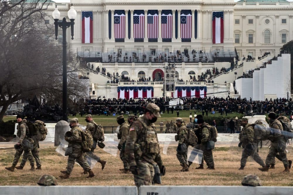 National Guard troops carry riot shields as they assume positions in the vicinity of the U.S. Capitol as the Inauguration of Joe Biden begins. (ROBERTO SCHMIDT/AFP via Getty Images)
