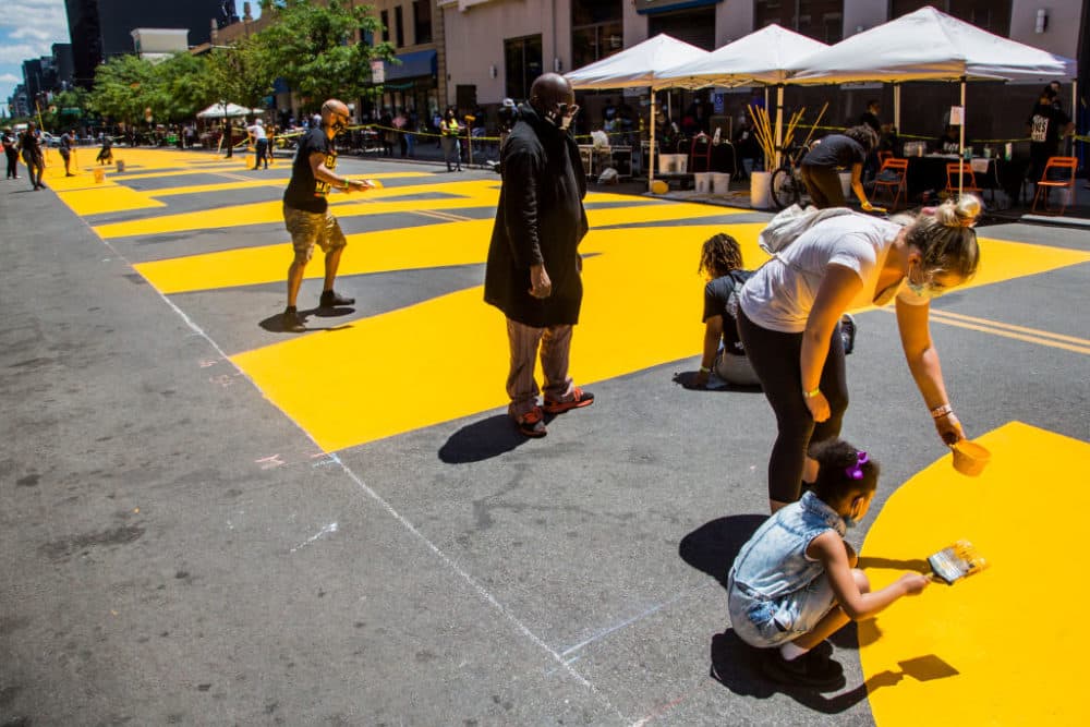 People work on the "Black Lives Matter" mural on Fulton St in the Bedford - Stuyvesant neighborhood on June 14, 2020 in Brooklyn, NY. (Pablo Monsalve/VIEWpress via Getty Images)