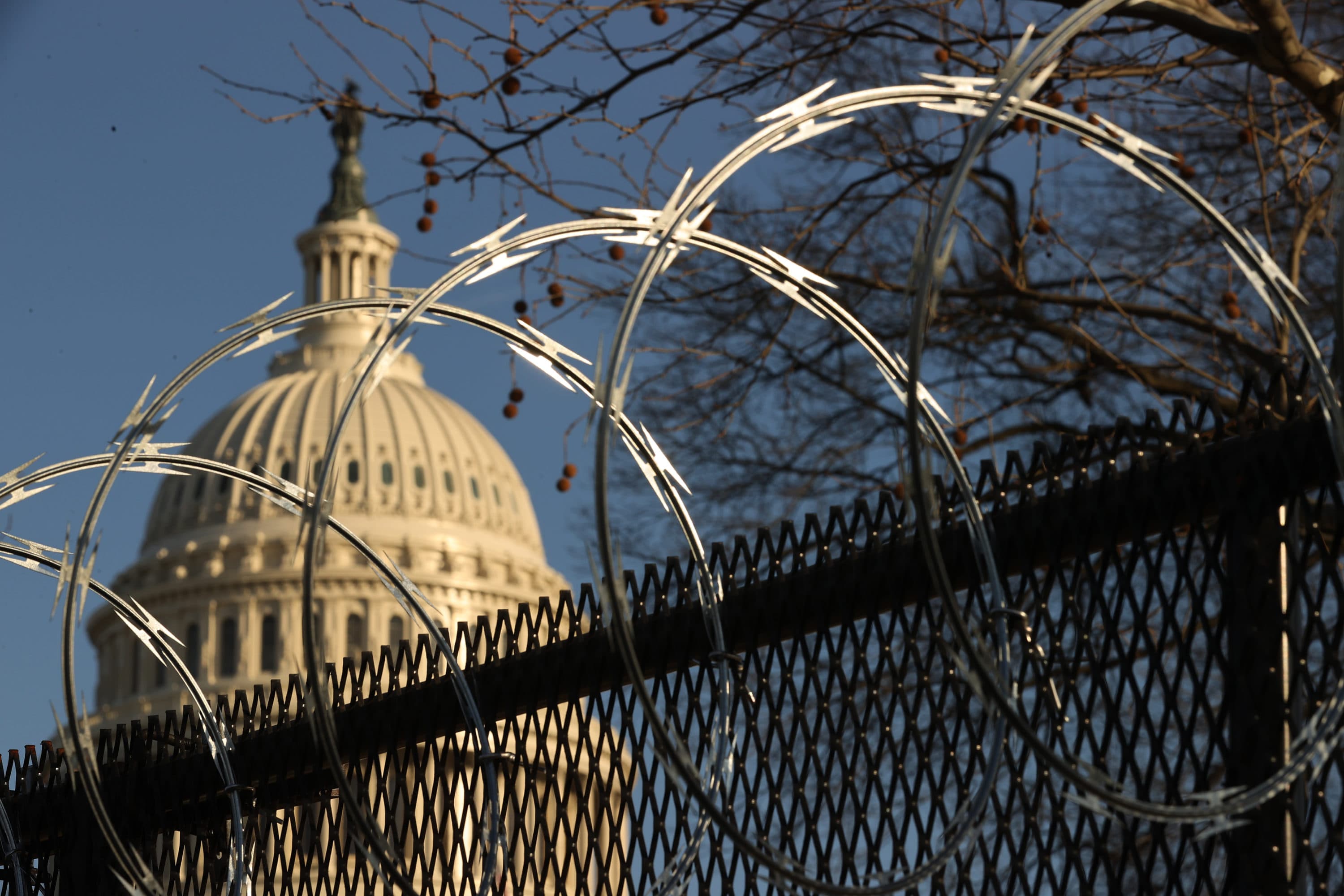 Concertina razor wire tops the 8-foot "non-scalable" fence that surrounds the U.S. Capitol on the day after the House voted to impeach former President Trump for the second time. (Chip Somodevilla/Getty Images)
