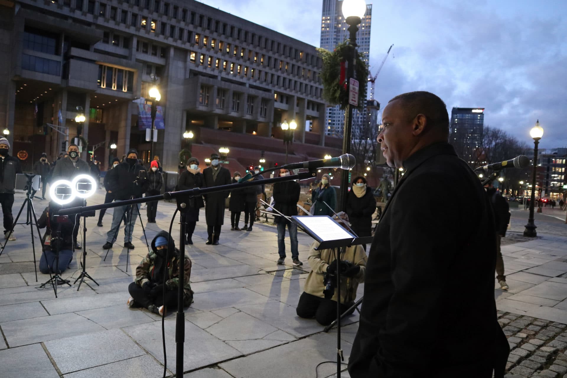 Kevin Peterson, a minister, speaks to a crowd gathered in front of Faneuil Hall in Boston on the eve of Martin Luther King Jr. Day in 2021. (Adrian Ma/WBUR)