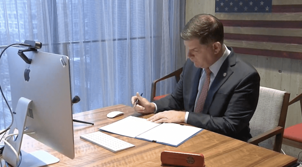Mayor Marty Walsh signs into law an ordinance creating the Office of Police Accountability and Transparency on Monday, Jan. 4. (Screenshot)