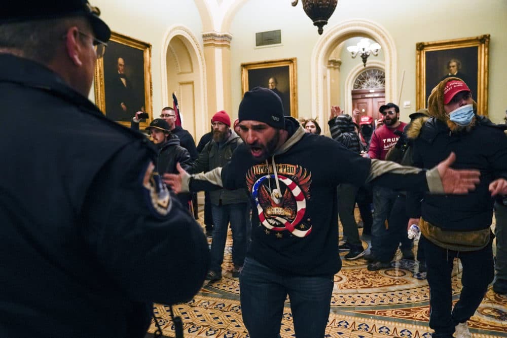 Protesters gesture to U.S. Capitol Police in the hallway outside of the Senate chamber inside the Capitol on Wednesday. (Manuel Balce Ceneta/AP)