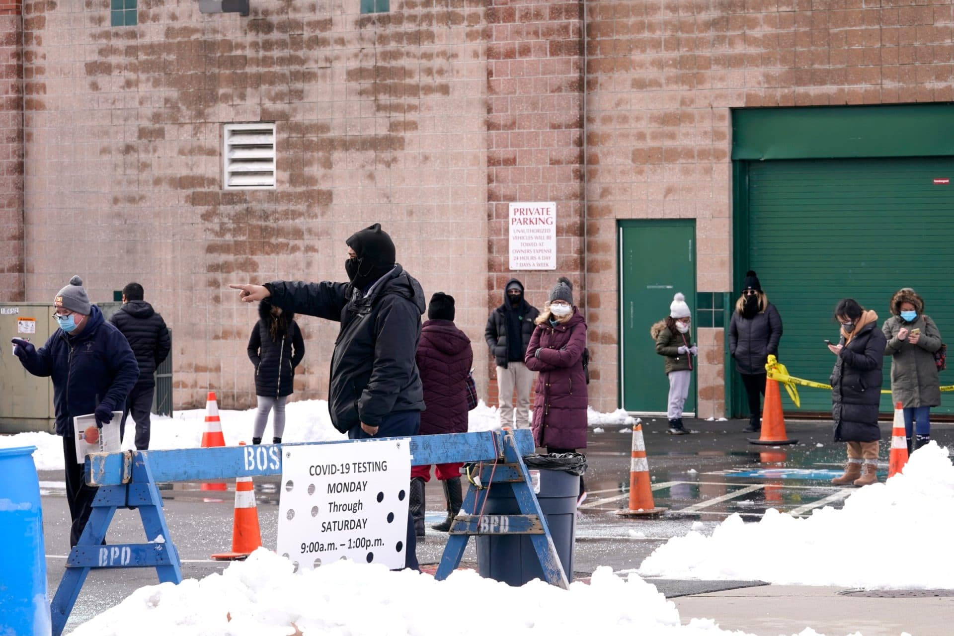 People in line are directed at the COVID-19 testing site in Roxbury. (Elise Amendola/AP)