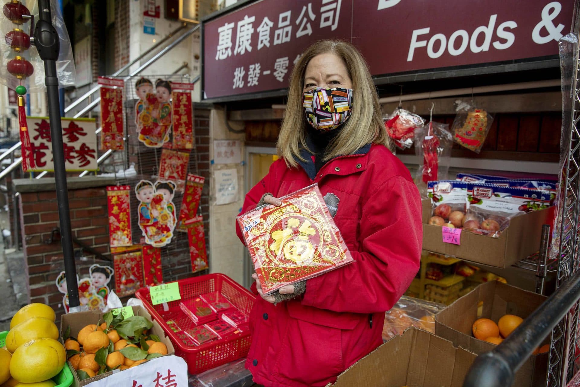 Culinary consultant Jacqueline Church surrounded by lunar new year items on display outside Delight Corner on Oxford Street. (Robin Lubbock/WBUR)