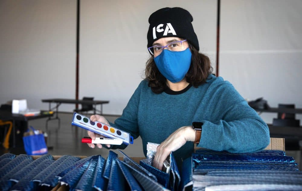 Director of education Monica Garza looks through the contents of one of the art kits at the ICA. (Robin Lubbock/WBUR)