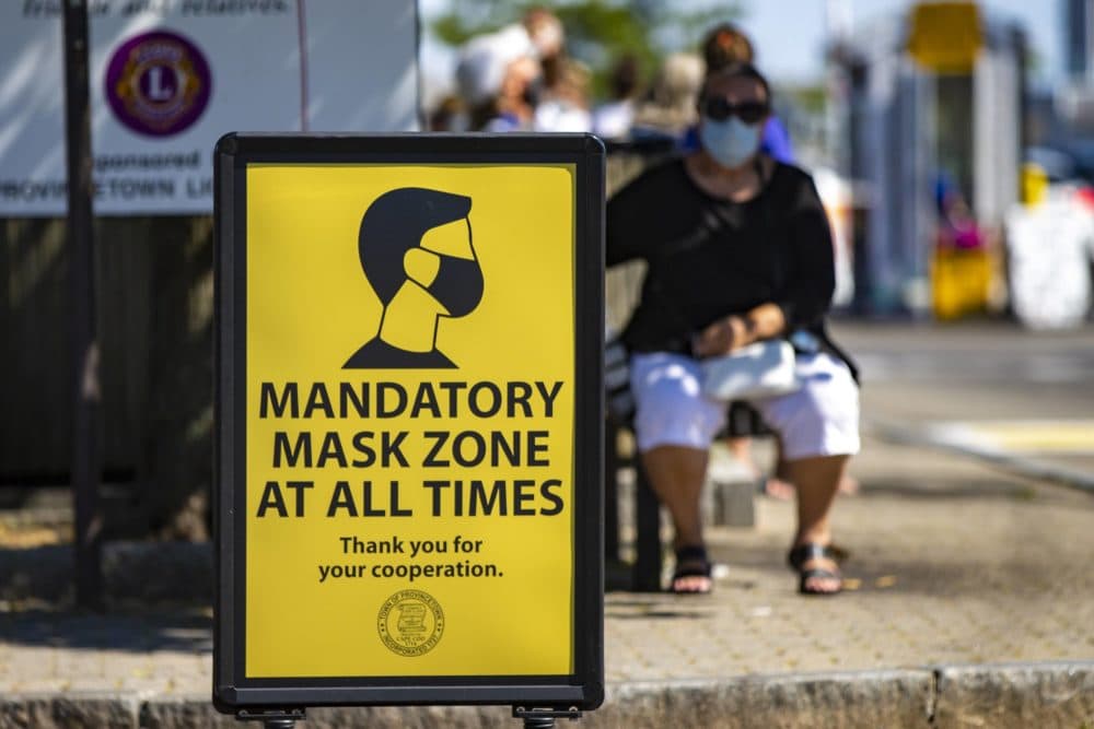 Signs in Provincetown this past summer remind everyone to wear a mask in public to help prevent the spread of coronavirus. (Jesse Costa/WBUR)