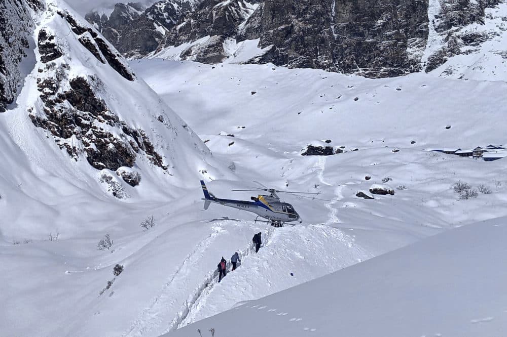 In this Jan. 18, 2020 photo, trekkers are being rescued in a helicopter a day after an avalanche hit Mount Annapurna trail in Nepal. (Phurba Ongel Sherpa/AP)