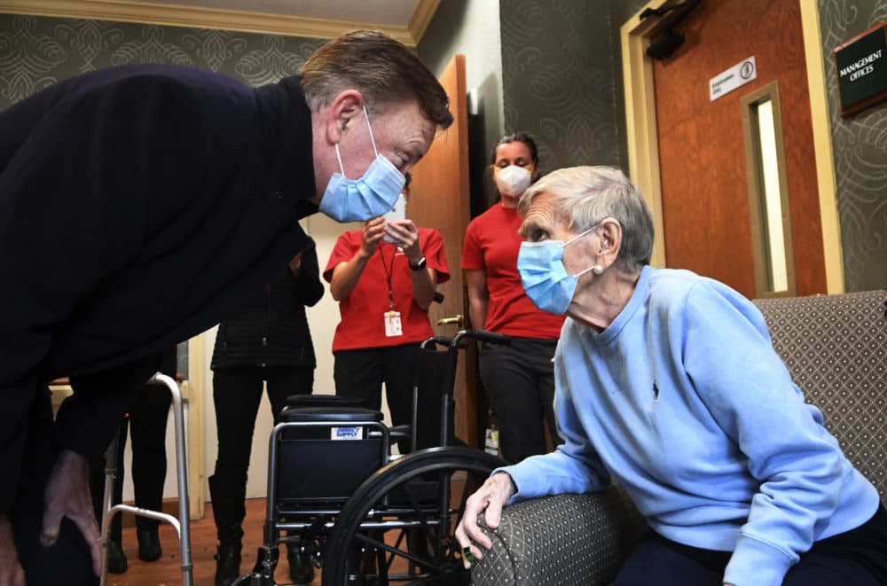 Gov. Ned Lamont greets 95-year-old Jeanne Peters, a rehab patient at a nursing facility. She was given the first COVID-19 vaccination at the nursing home on Dec. 18, 2020, in West Hartford, Conn. (Stephen Dunn/AP/Pool)