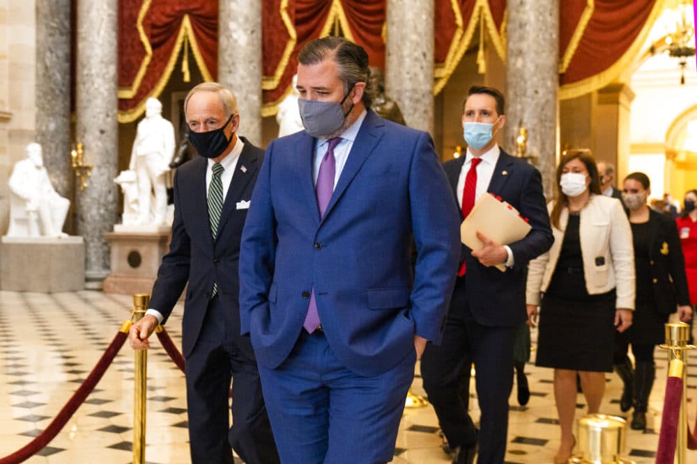 Sen. Ted Cruz, R-Texas, front, followed by Sen. Josh Hawley, R-Mo., walk from the House Chamber following a Senate procession carrying boxes holding Electoral College votes to the House Chamber for a joint session to confirm the Electoral College votes. (Manuel Balce Ceneta/AP Photo)