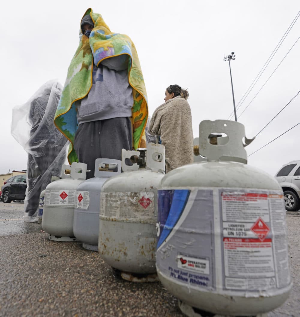 Carlos Mandez waits in line to fill his propane tanks Wednesday, Feb. 17, 2021, in Houston. Customers had to wait over an hour in the freezing rain to fill their tanks. Millions in Texas still had no power after a historic snowfall and single-digit temperatures created a surge of demand for electricity to warm up homes unaccustomed to such extreme lows, buckling the state's power grid and causing widespread blackouts. (David J. Phillip/AP)