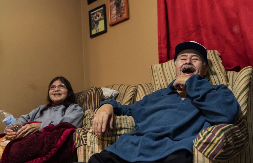 Mario Valdez, 62, right, laughs while watching television with his wife, Reyna, 52, at their home in Central Falls, R.I., Feb. 18, 2021. &quot;(David Goldman/AP)