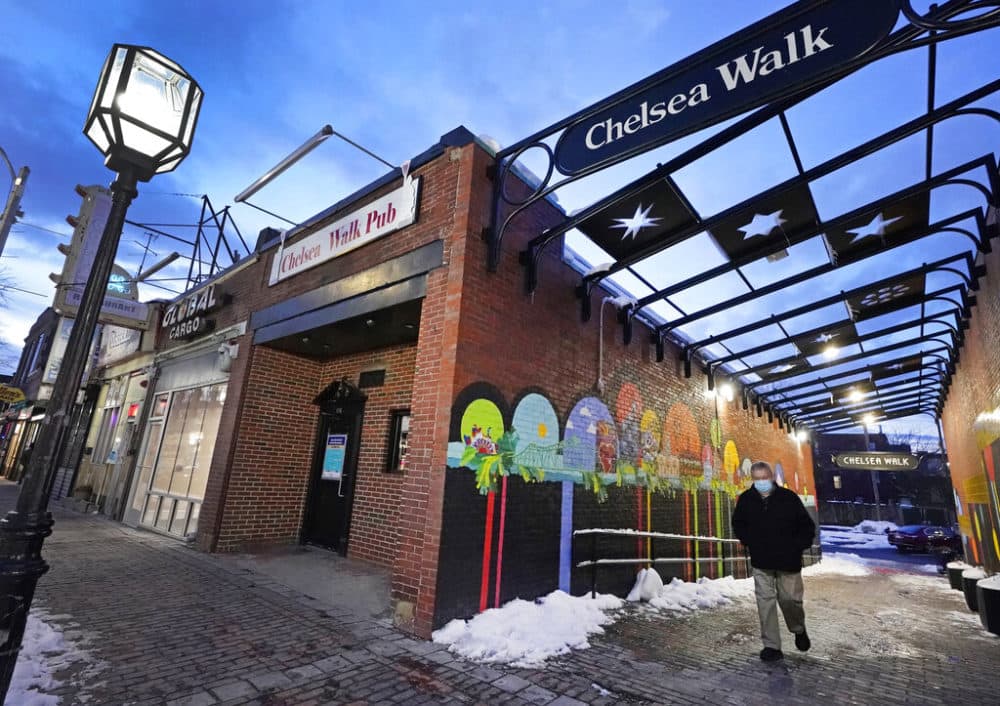 A man walks in downtown Chelsea, Mass., Feb. 10, 2021. (Elise Amendola/AP)