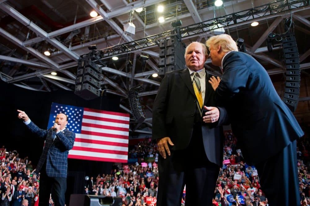 Donald Trump speaks to radio talk show host Rush Limbaugh (C), while Lee Greenwood performs "God Bless The USA", at a Make America Great Again rally in Cape Girardeau, Missouri on November 5, 2018. (Jim Watson/ AFP via Getty Images)
