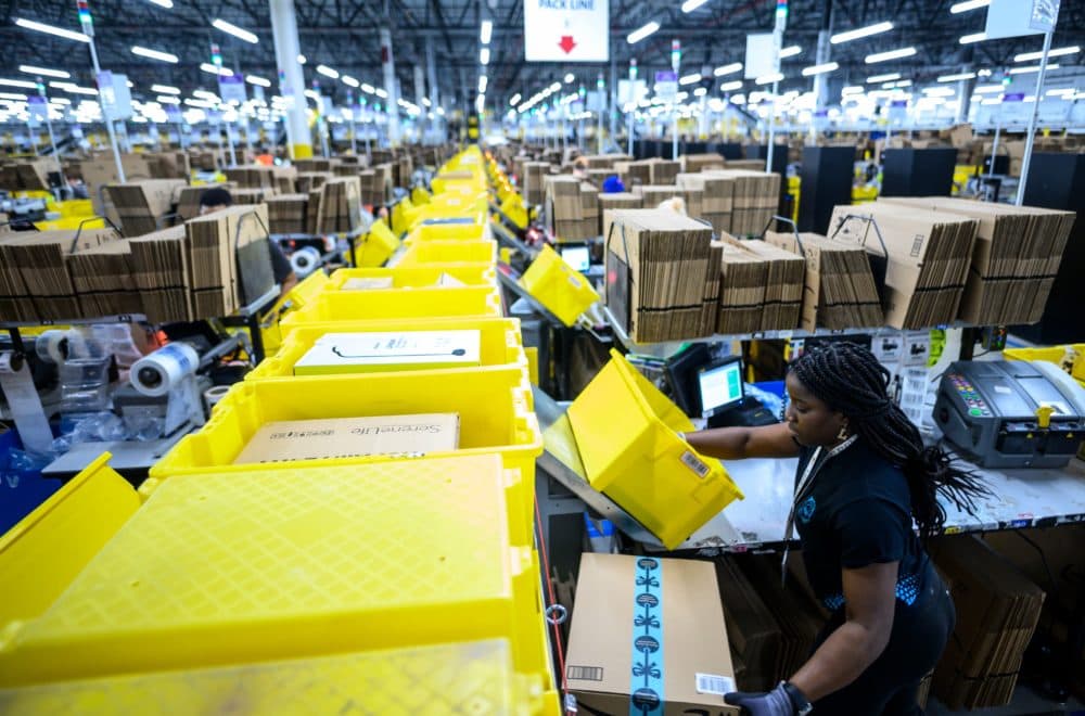 A woman works at a packing station in Amazon's fulfillment center in Staten Island. (Johannes Eisele/AFP via Getty Images)