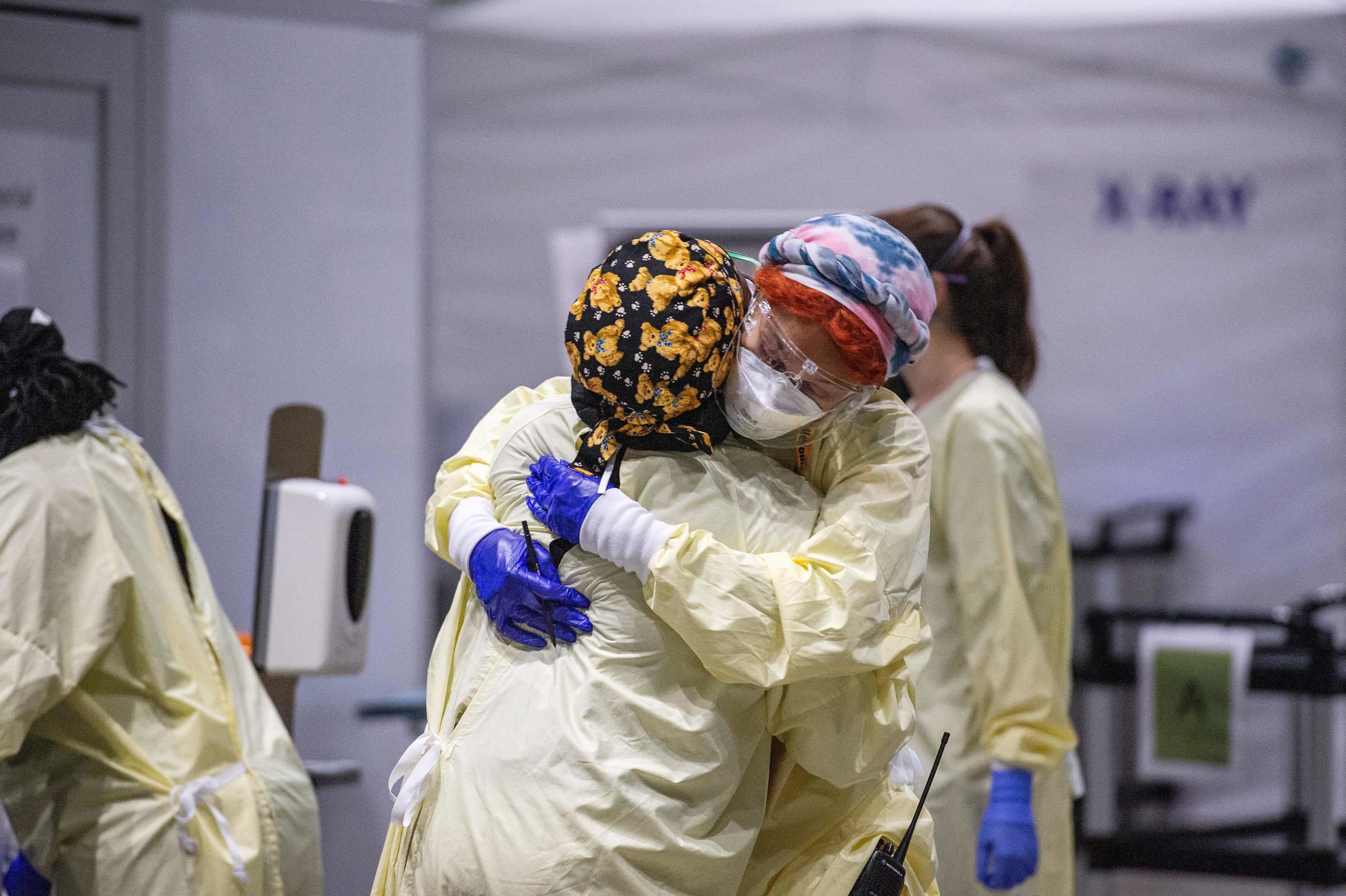 Medical worker Margaret Watkins embraces co-worker Shelly Burke as part of their morning therapy, a family check in. (JOSEPH PREZIOSO/AFP via Getty Images)