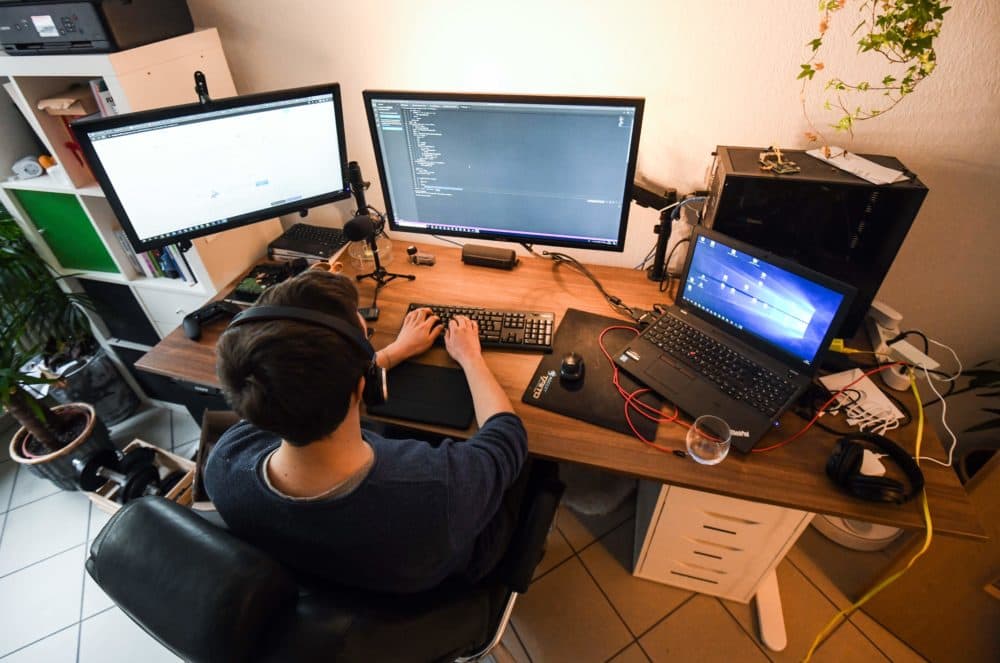 A computer scientist works in his home office (Ina Fassbender/AFP via Getty Images)