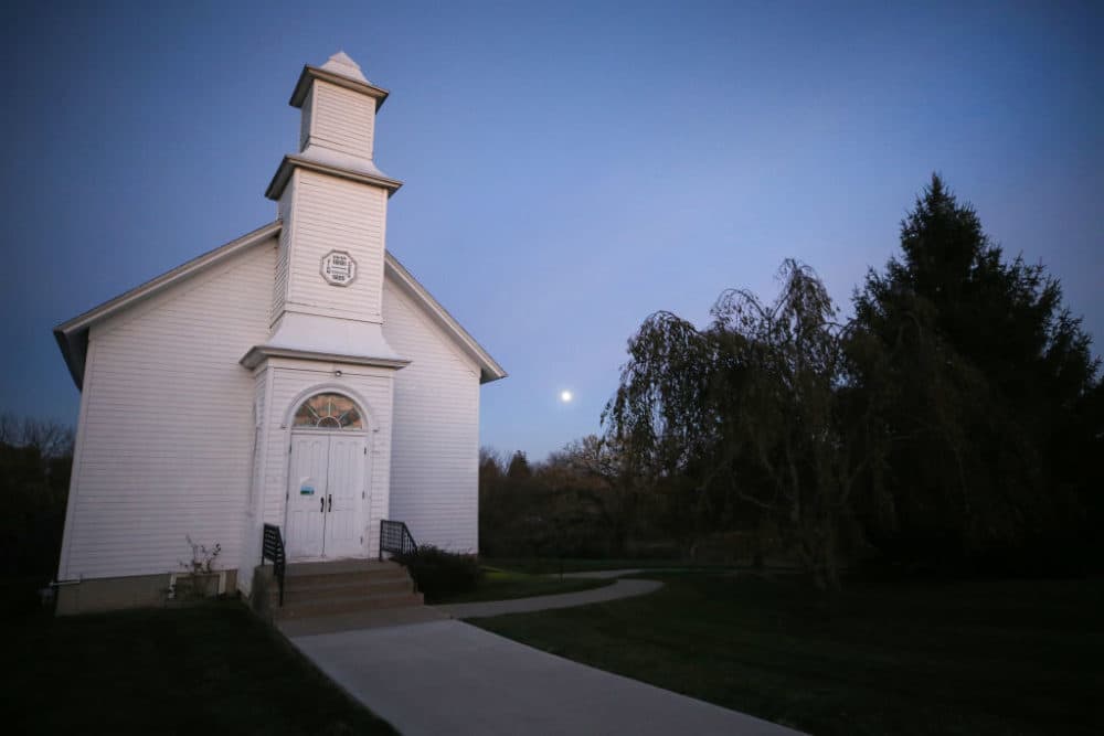 The moon rises behind Zion Church, built in 1881, at the Madison County Historical Society on October 29, 2020 in Winterset, Iowa. (Mario Tama/Getty Images)