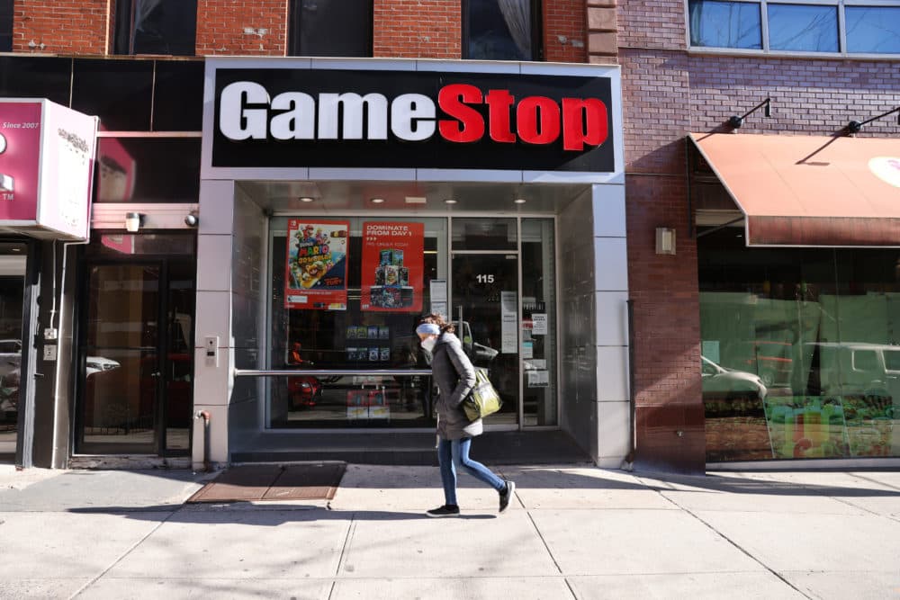 People walk by a GameStop store in Brooklyn on January 28, 2021 in New York City. Markets continue a volatile streak with the Dow Jones Industrial Average rising over 500 points in morning trading following yesterdays losses. Shares of the video game retailer GameStop plunged. (Spencer Platt/Getty Images)