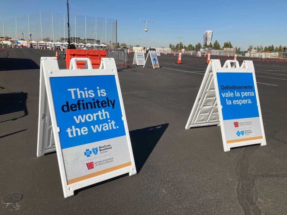 Signs outside of Arizona Cardinal's stadium vaccination site. (Peter O'Dowd/Here &amp; Now)