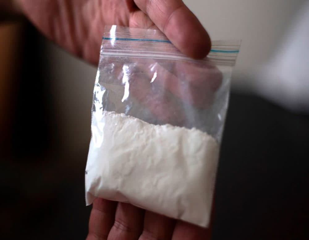 A cocaine consumer shows a bag of the drug. (Juan Manuel Barrero/AFP/Getty Images)