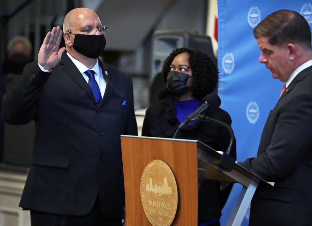 Dennis White, left, was sworn in by Mayor Marty Walsh, right, as the city's new police commissioner. ) White's wife, Jackie, stands off to White's left.(Jim Davis/Boston Globe)