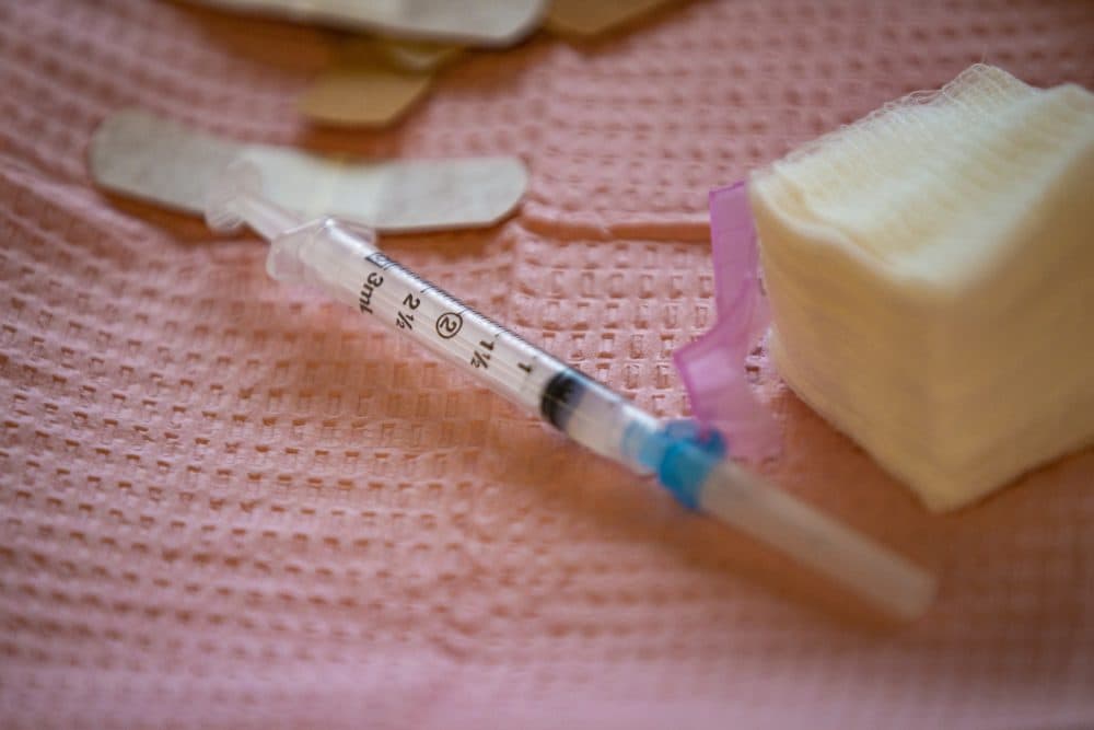 A syringe filled with the Moderna COVID-19 vaccine. (Jesse Costa/WBUR)