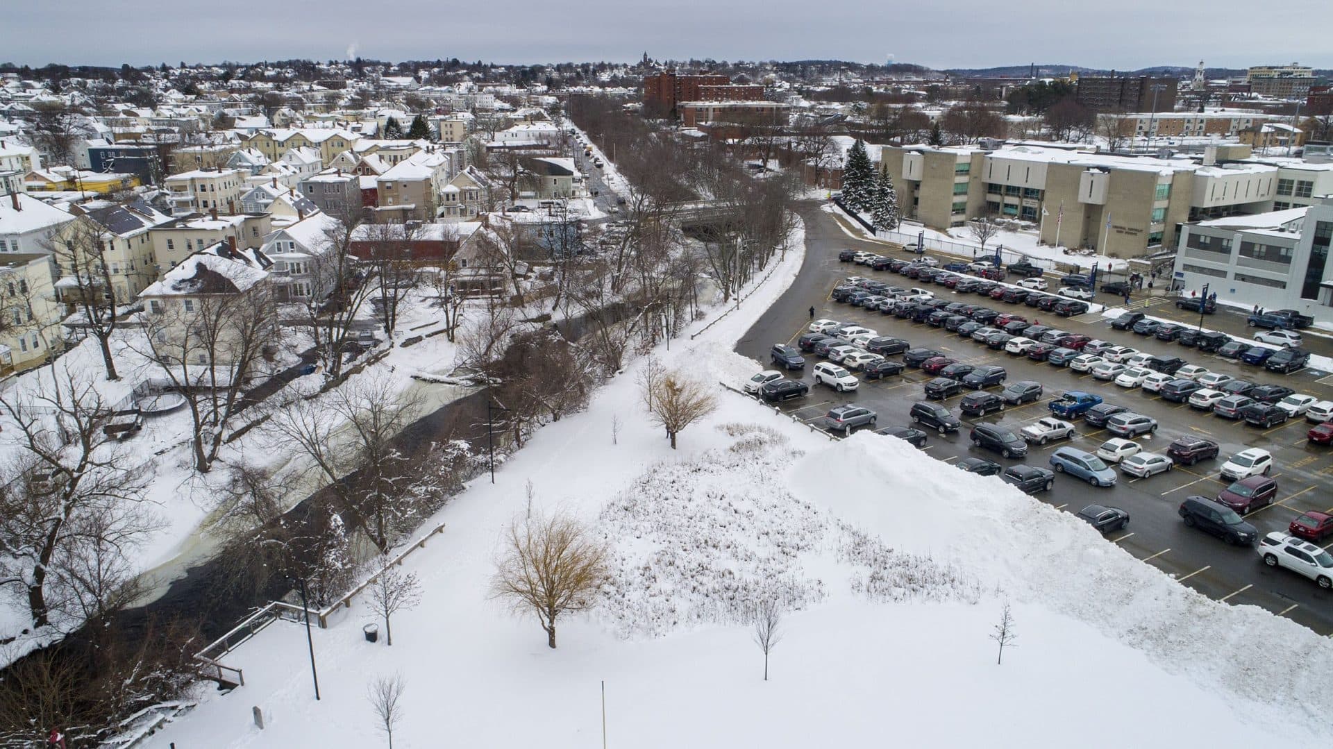 The marshy triangle in the foreground of this image is a wetland area designed to capture rainwater runoff from the parking lot of Central Catholic High School in Lawrence, before it reaches the Spicket River. (Robin Lubbock/WBUR)