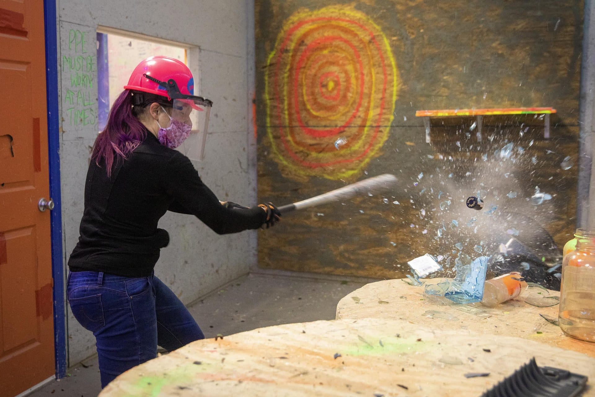 A liquor bottle takes a direct hit as Danielle Blanchard smashes her way through her appointment. (Robin Lubbock/WBUR)